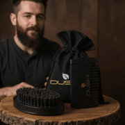 Black dushi grooming brush set with a black bag on a wooden surface, man in background