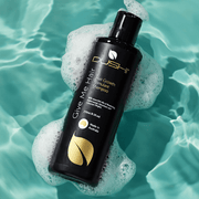 Dushi hair care product bottle with shampoo on a water background