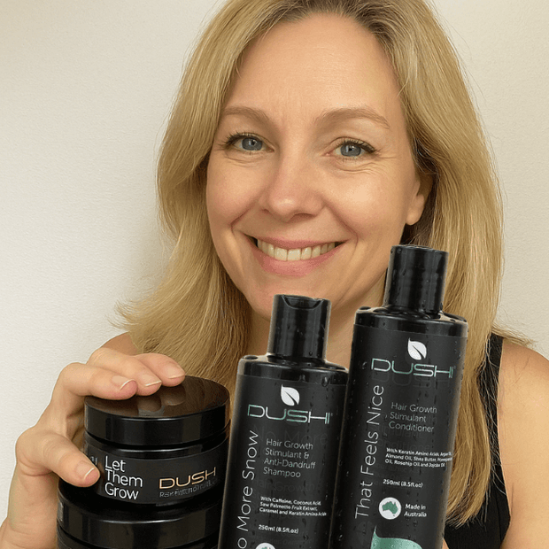 Australian made postpartum hair care products by DUSHI held by smiling blonde woman