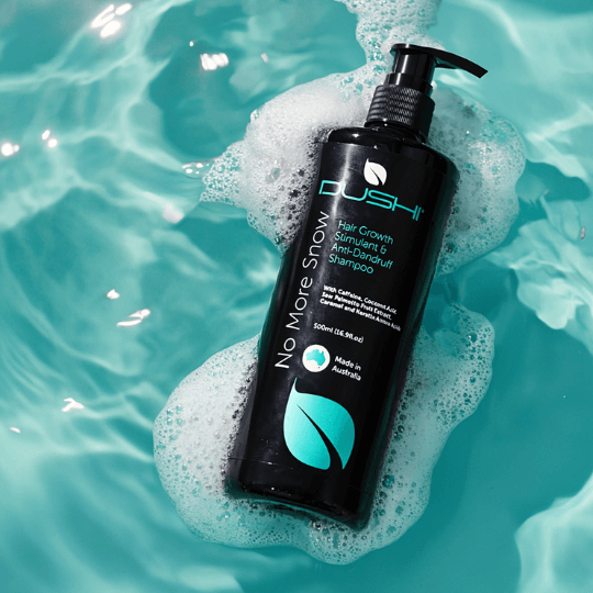 Dushi No More Snow shampoo bottle in water with bubbles